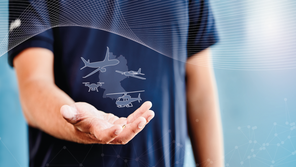 Schmuckbild: Hand, über der eine Deutschladnkarte sowie mehrere Fluggeräte zu sehen sind